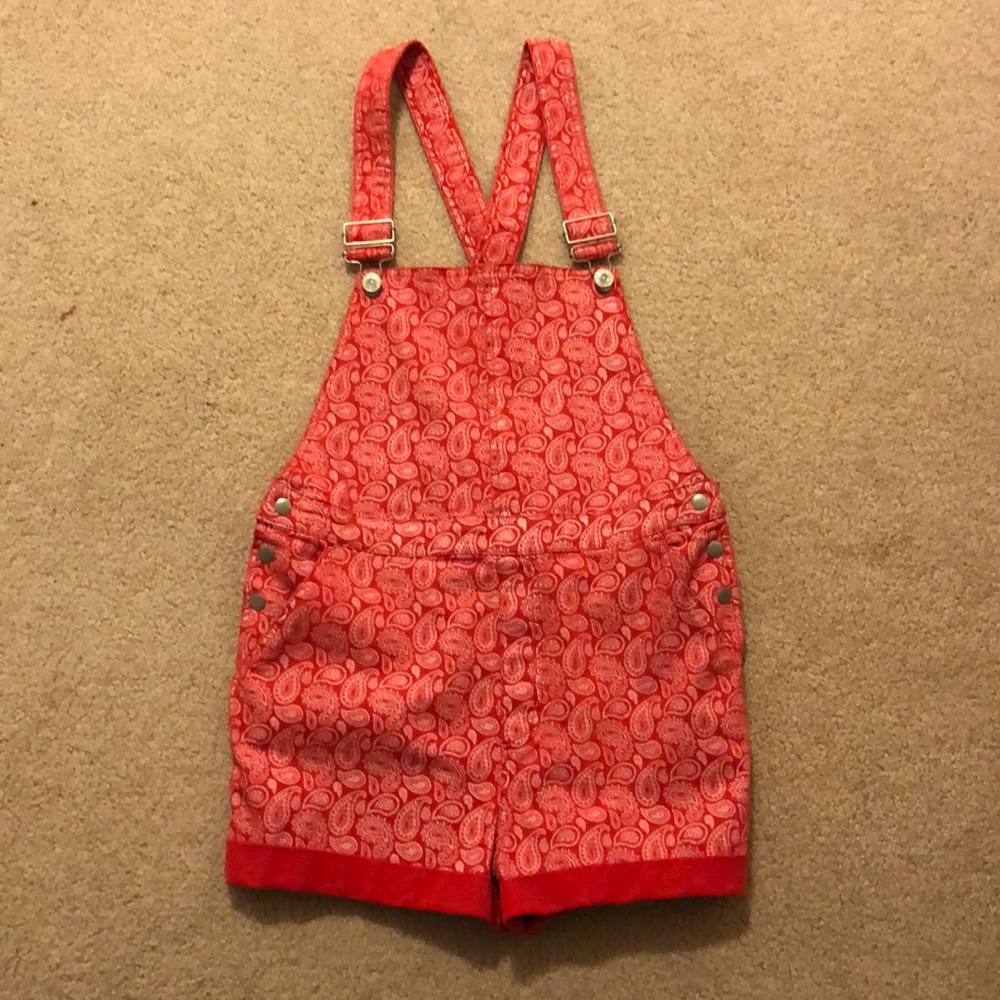 Red overalls with a white paisley pattern. (BDG)